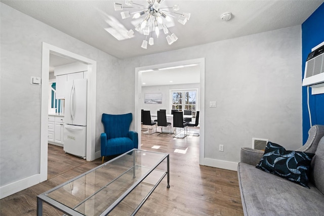 living room featuring hardwood / wood-style flooring and a notable chandelier