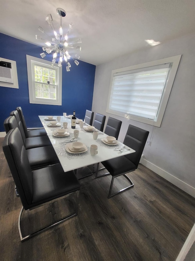 dining space with dark wood-type flooring and an inviting chandelier