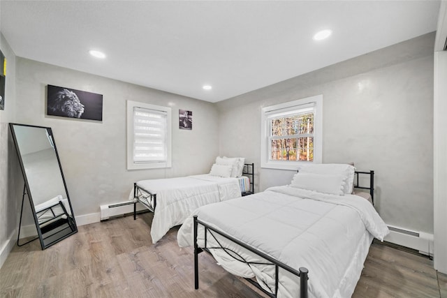 bedroom featuring wood-type flooring and baseboard heating