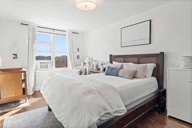 bedroom featuring cooling unit and dark wood-type flooring