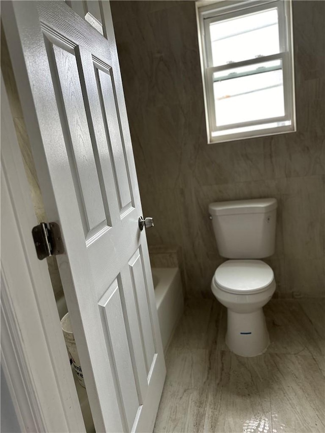 bathroom with hardwood / wood-style floors and toilet