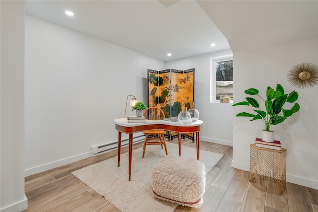 home office featuring light hardwood / wood-style floors and a baseboard radiator