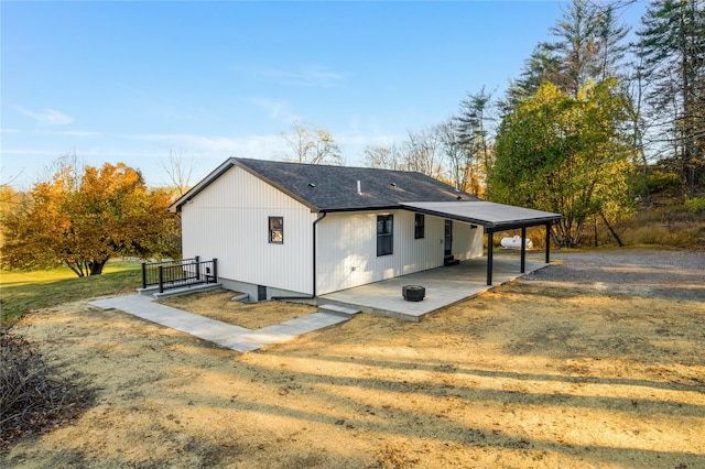 back of property with a yard and a patio area