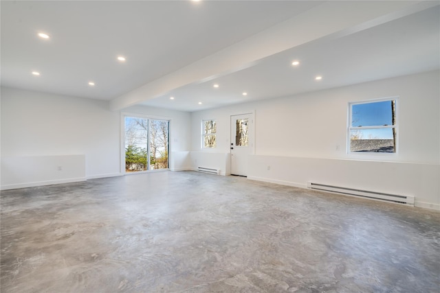 unfurnished room with a wealth of natural light, beamed ceiling, concrete floors, and a baseboard heating unit