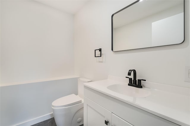 bathroom with tile patterned floors, vanity, and toilet