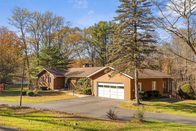 ranch-style home featuring a garage and a front lawn