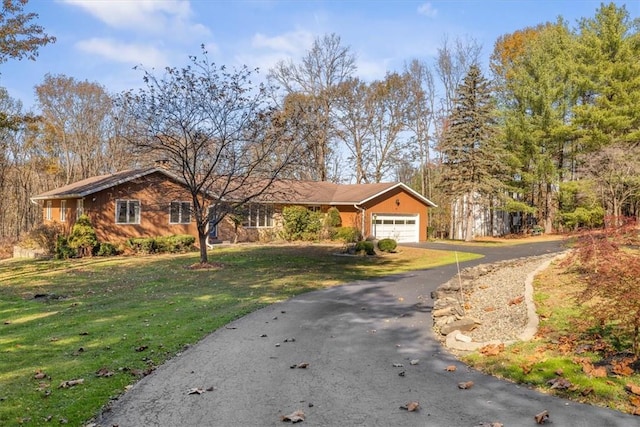 ranch-style home featuring a garage and a front yard