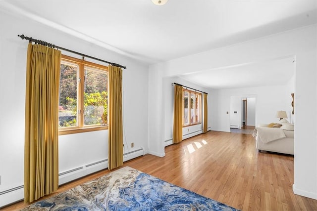 empty room featuring light hardwood / wood-style floors and baseboard heating