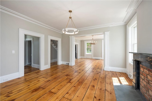 interior space featuring crown molding, a notable chandelier, and light wood-type flooring