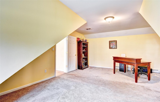 interior space featuring light colored carpet and vaulted ceiling