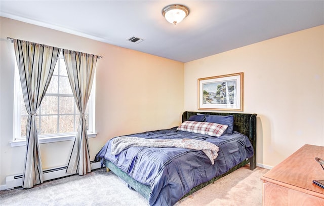 bedroom with baseboard heating and light carpet