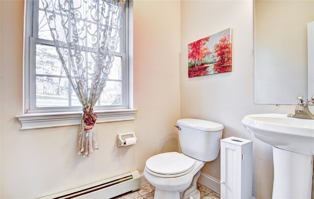 bathroom featuring toilet, tile patterned flooring, and a baseboard heating unit