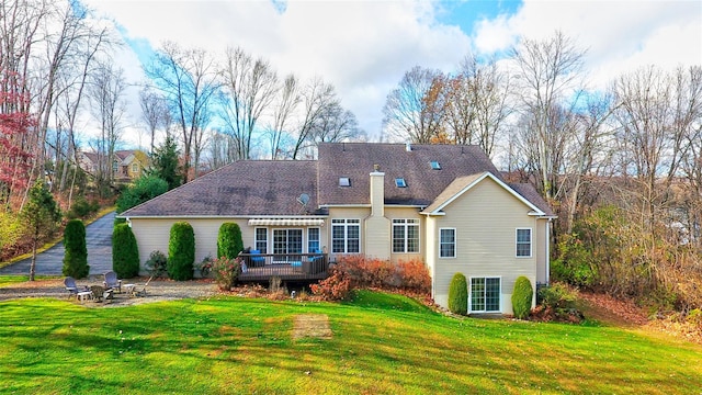 back of property featuring a yard and a deck