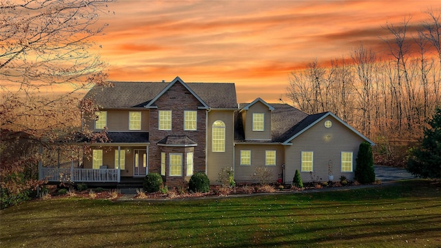 view of front of house with a lawn and covered porch