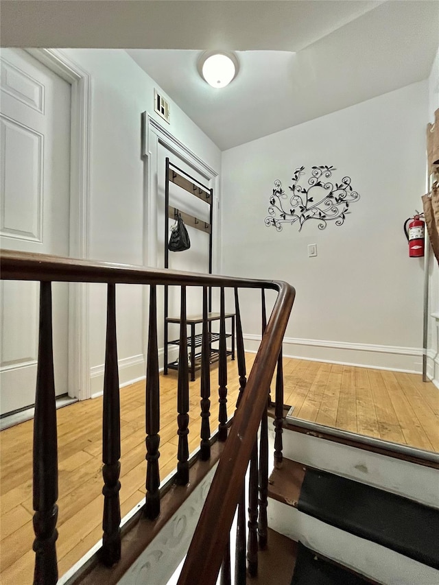 stairs featuring hardwood / wood-style flooring