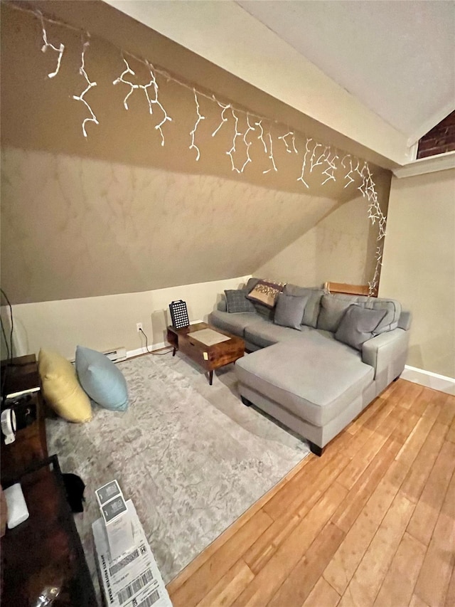 living room with wood-type flooring and vaulted ceiling