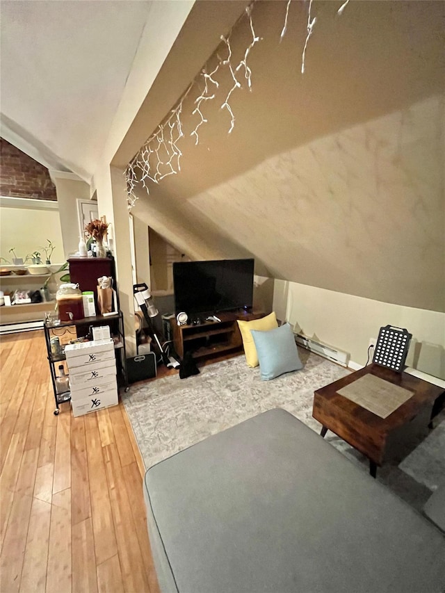 living room featuring lofted ceiling and hardwood / wood-style flooring