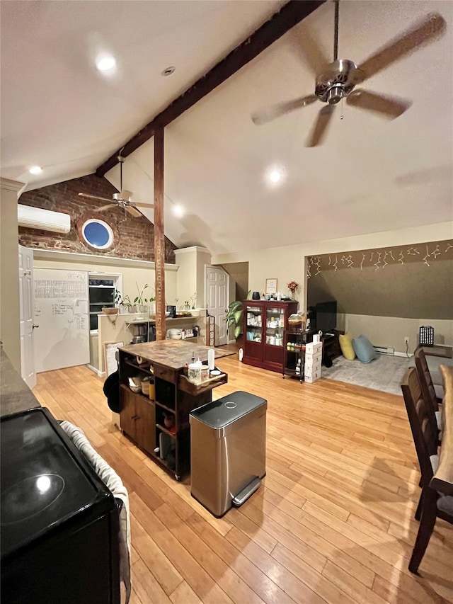 living room with vaulted ceiling with beams and light hardwood / wood-style flooring