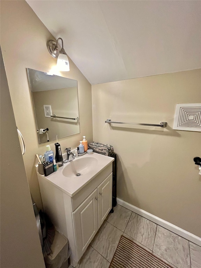 bathroom featuring vanity and vaulted ceiling