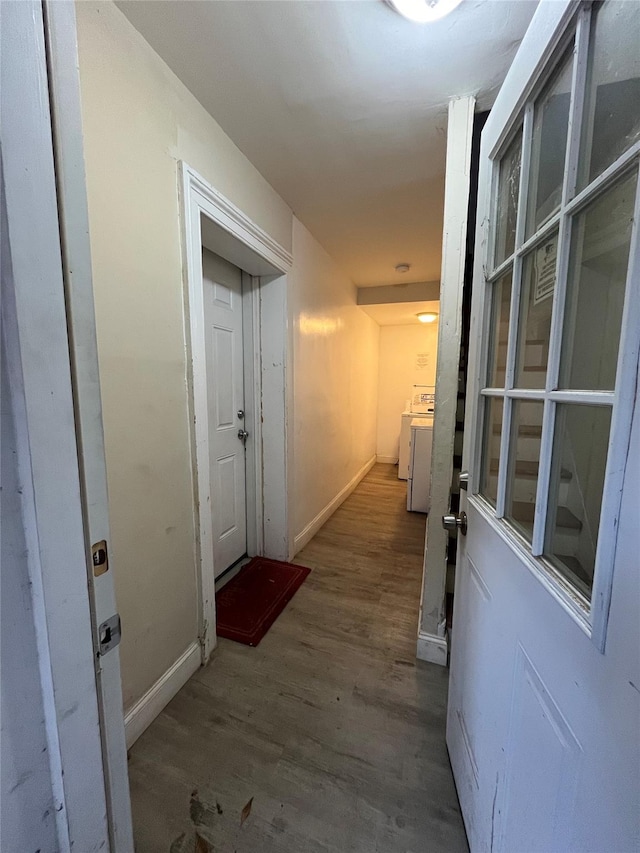 hallway featuring washer / clothes dryer and dark hardwood / wood-style flooring