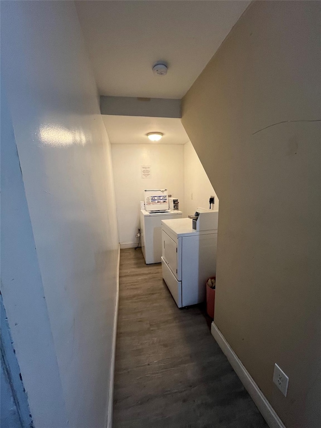 clothes washing area featuring dark hardwood / wood-style flooring and washing machine and dryer