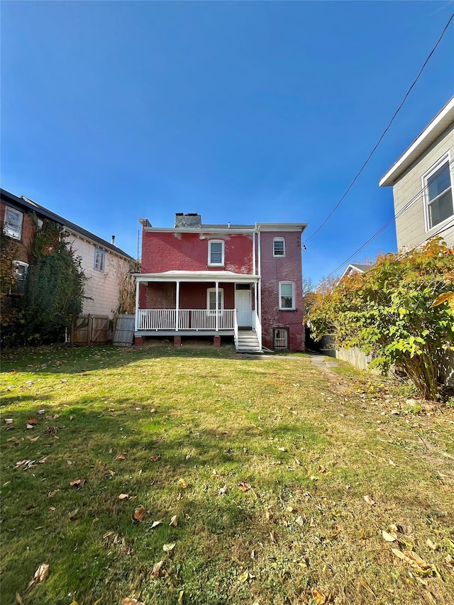 back of house with a lawn