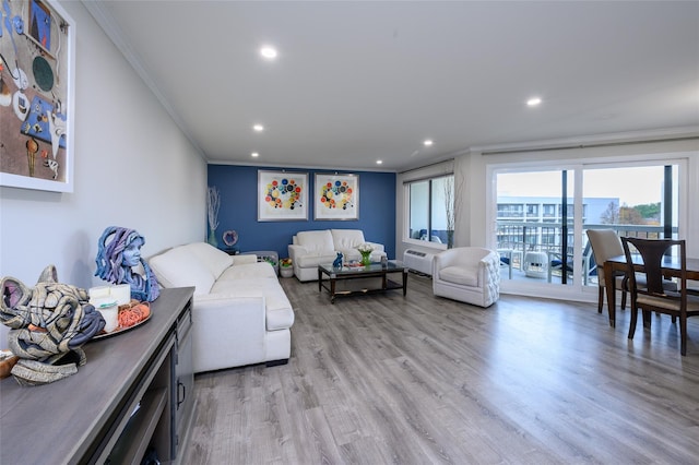 living room with ornamental molding and light hardwood / wood-style flooring