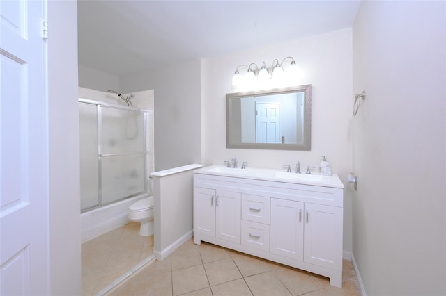 full bathroom featuring shower / bath combination with glass door, tile patterned flooring, vanity, and toilet