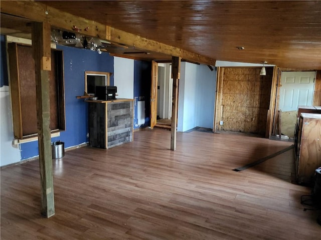 unfurnished living room featuring hardwood / wood-style flooring and wood ceiling