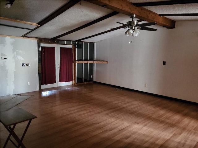 unfurnished living room with hardwood / wood-style floors, vaulted ceiling with beams, a textured ceiling, and ceiling fan