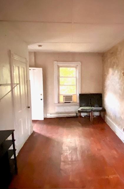 misc room featuring baseboard heating, hardwood / wood-style floors, and cooling unit