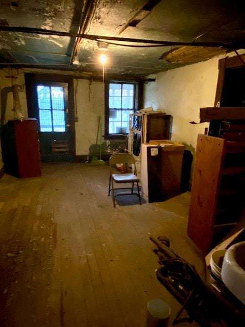 basement with hardwood / wood-style floors, fridge, and a wealth of natural light