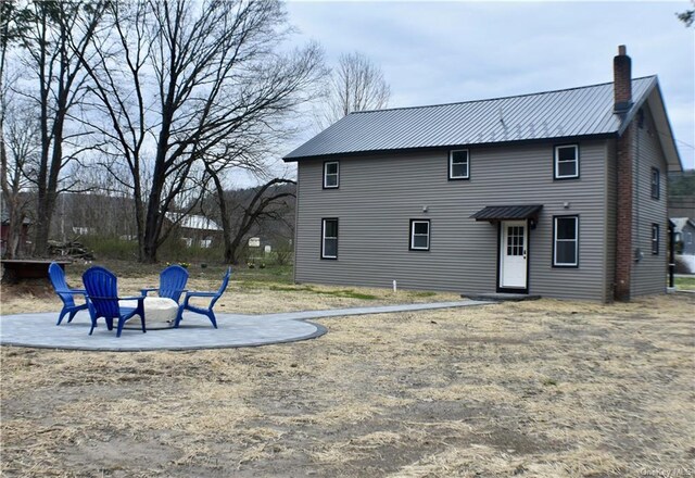 7065 Rte 209, Kerhonkson, NY 12446 - back of house featuring a chimney, a fire pit, metal roof, and a patio