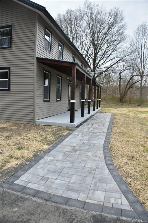 view of side of property featuring a patio area