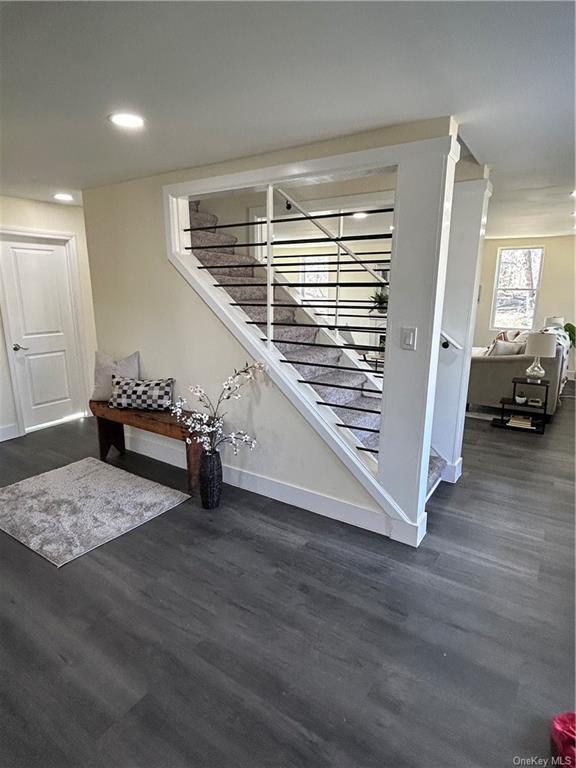 7065 Rte 209, Kerhonkson, NY 12446 - staircase with baseboards, wood finished floors, and recessed lighting