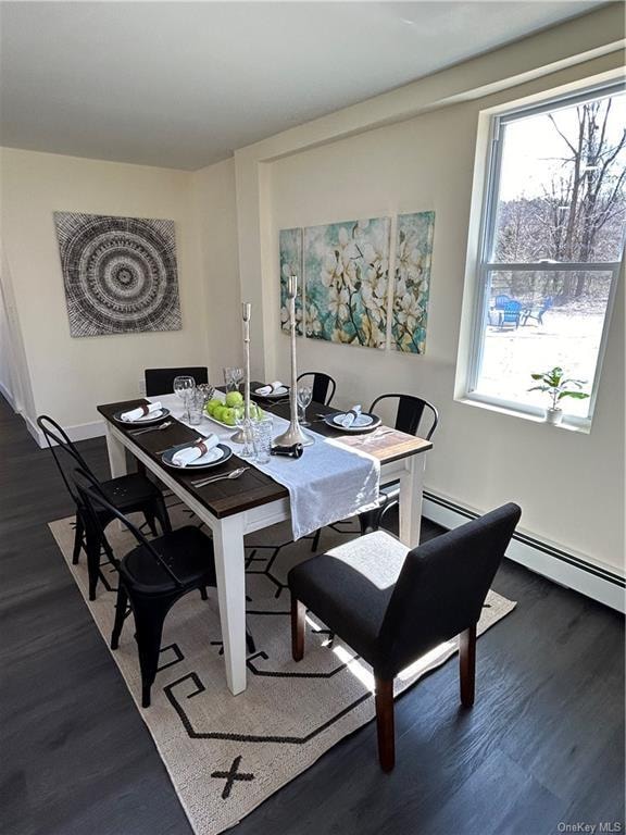 dining area with dark hardwood / wood-style floors and baseboard heating