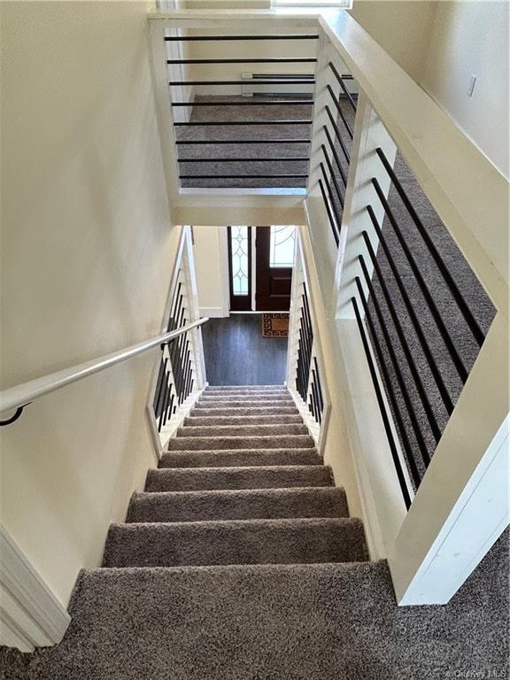 stairway featuring wood-type flooring