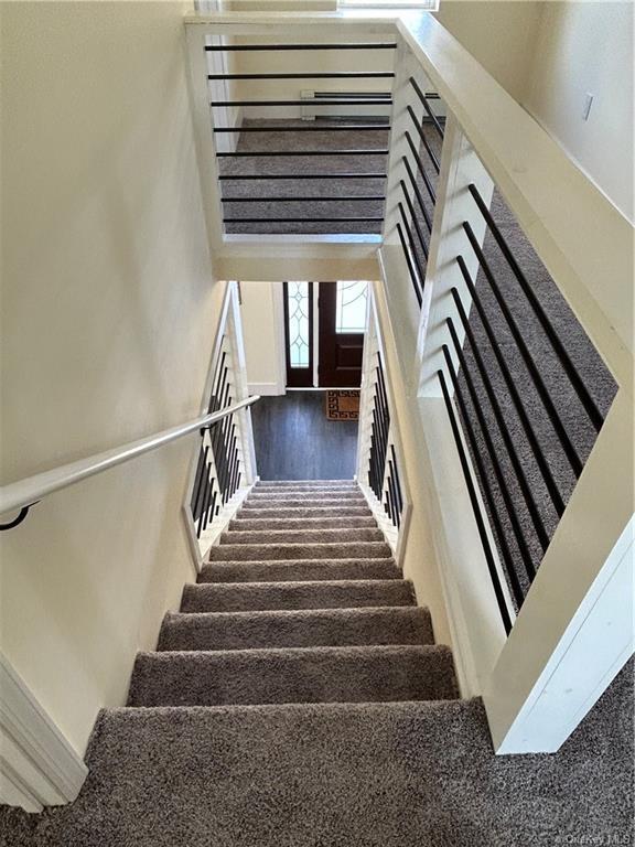 7065 Rte 209, Kerhonkson, NY 12446 - stairway with a high ceiling and wood finished floors