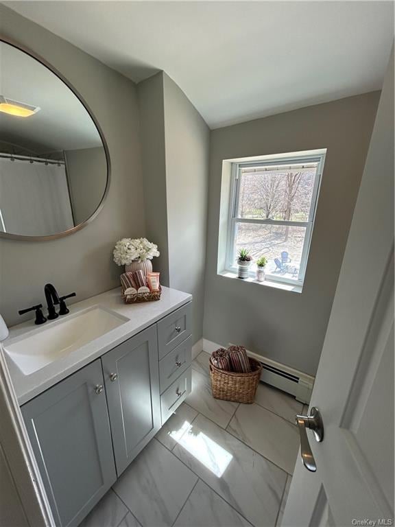 bathroom with baseboard heating and vanity