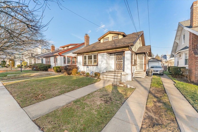 bungalow-style home featuring a front yard