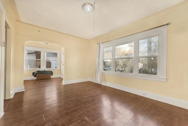 interior space featuring dark hardwood / wood-style floors, ceiling fan, and a textured ceiling