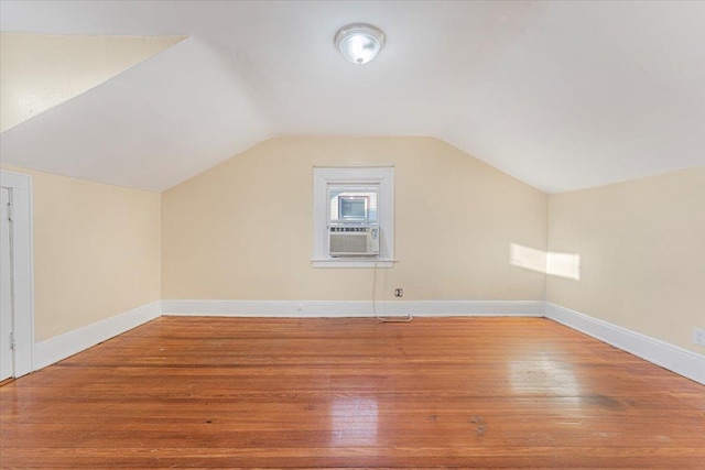 bonus room featuring hardwood / wood-style flooring, vaulted ceiling, and cooling unit