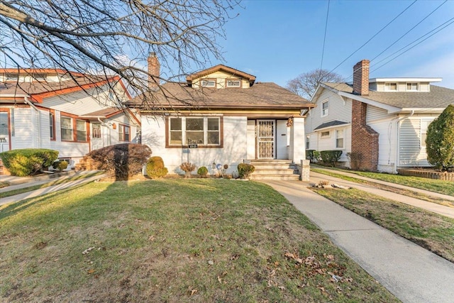 bungalow-style home with a front lawn