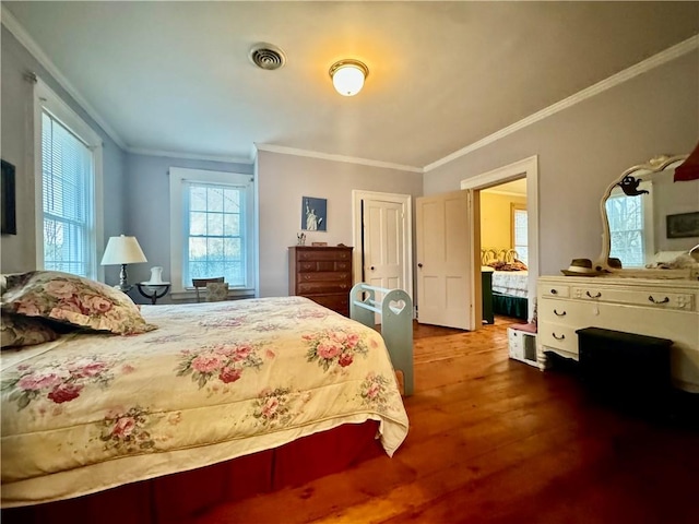 bedroom featuring hardwood / wood-style flooring and ornamental molding