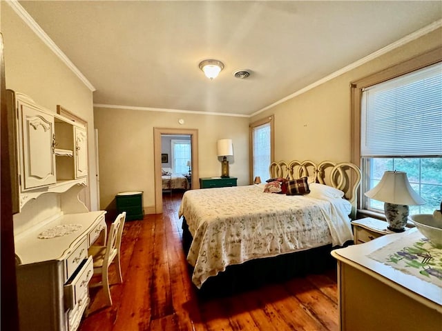 bedroom with dark hardwood / wood-style flooring and crown molding