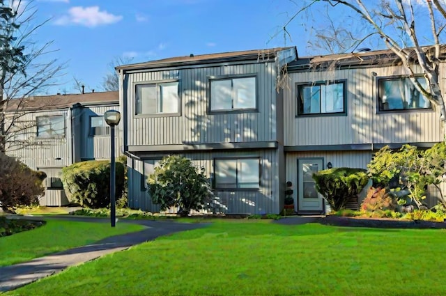 rear view of property featuring a yard