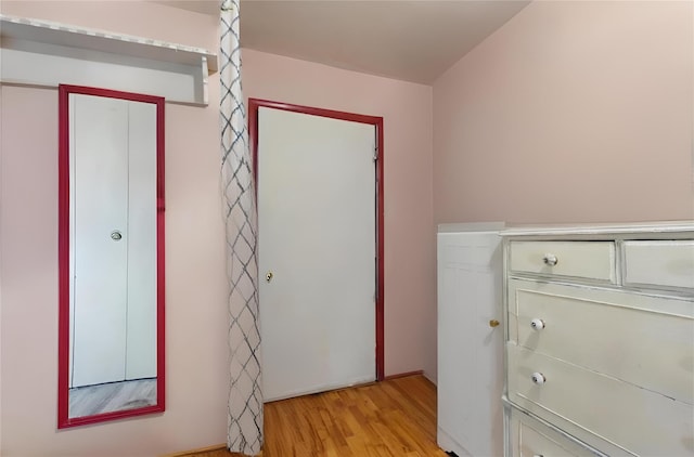 clothes washing area featuring light hardwood / wood-style floors