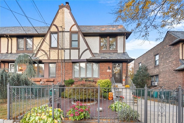 tudor-style house featuring cooling unit