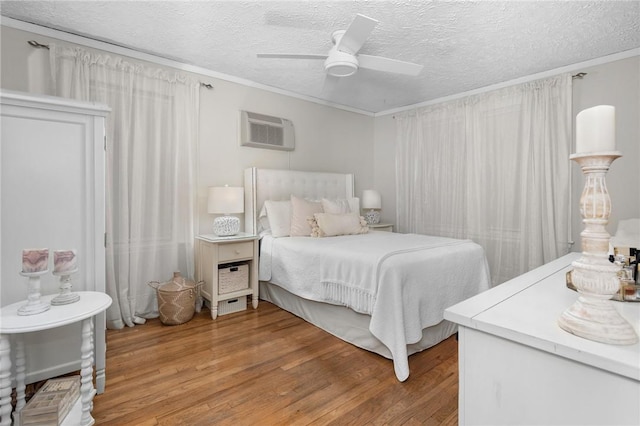 bedroom featuring wood-type flooring, a textured ceiling, and ceiling fan