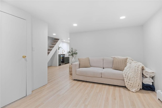 living room with light hardwood / wood-style flooring and a baseboard radiator